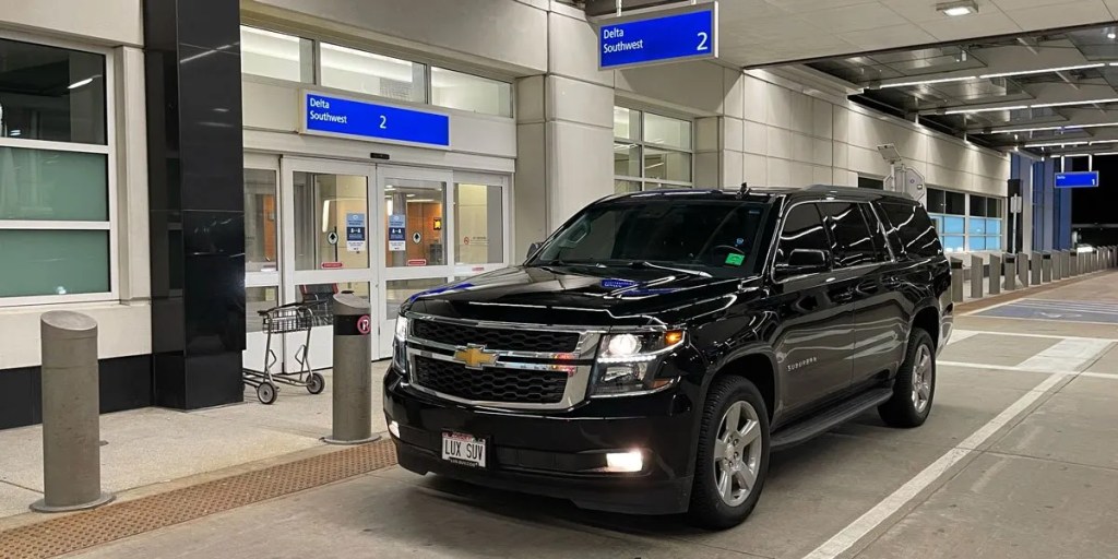 Black Elite Rides Luxury SUV at an airport terminal